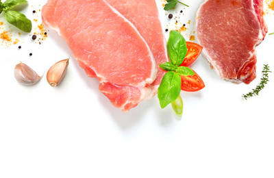 a pork chop and shoulder mean with basil leaves, garlic cloves, and spices.